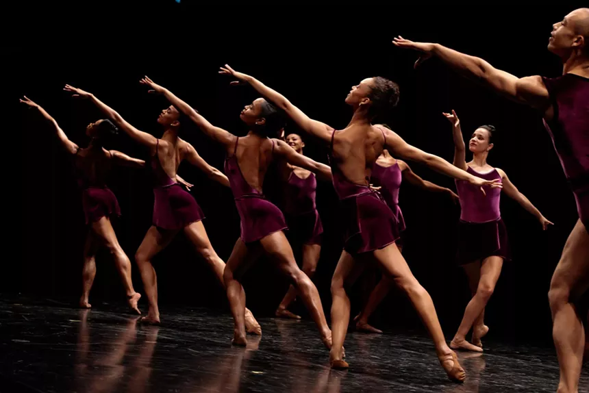 Ballet dancers stretch their arms out