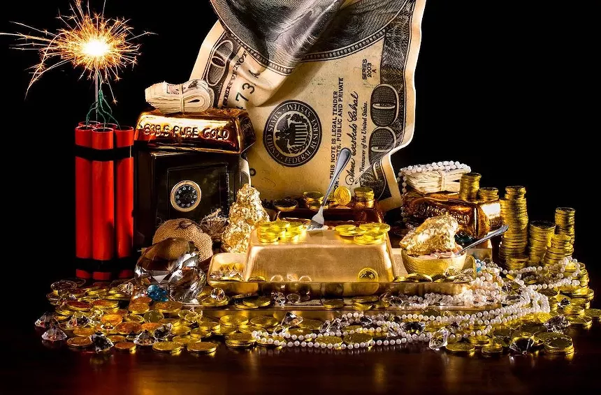 A lavish dessert tray with gold-covered chocolate and cakes