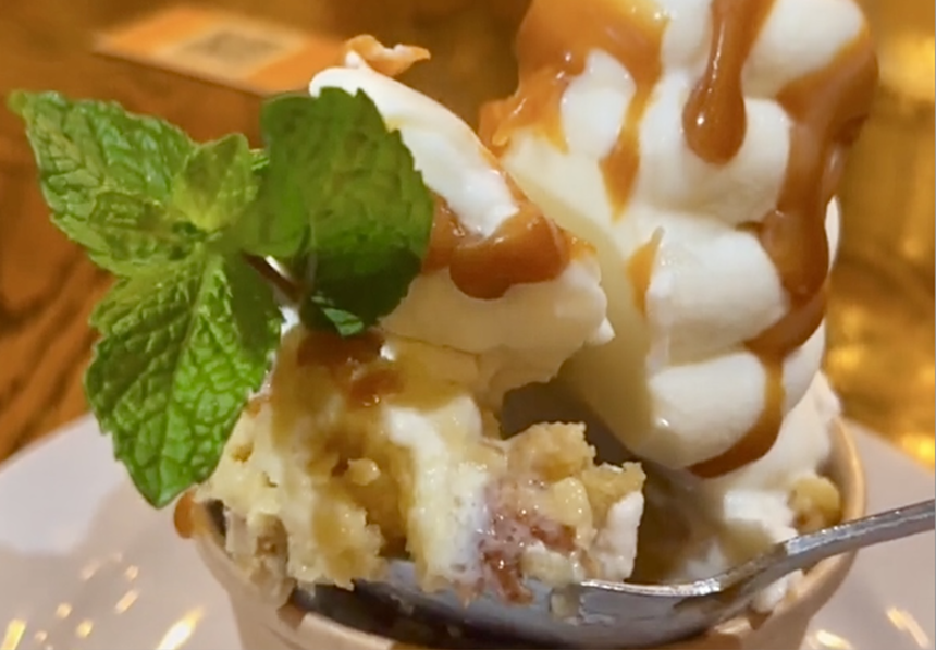 Vanilla soft-serve ice cream over bread pudding