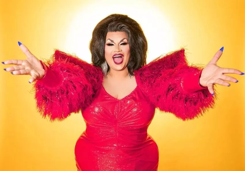 Ada Vox is a sequin red dress with feathered sleeves
