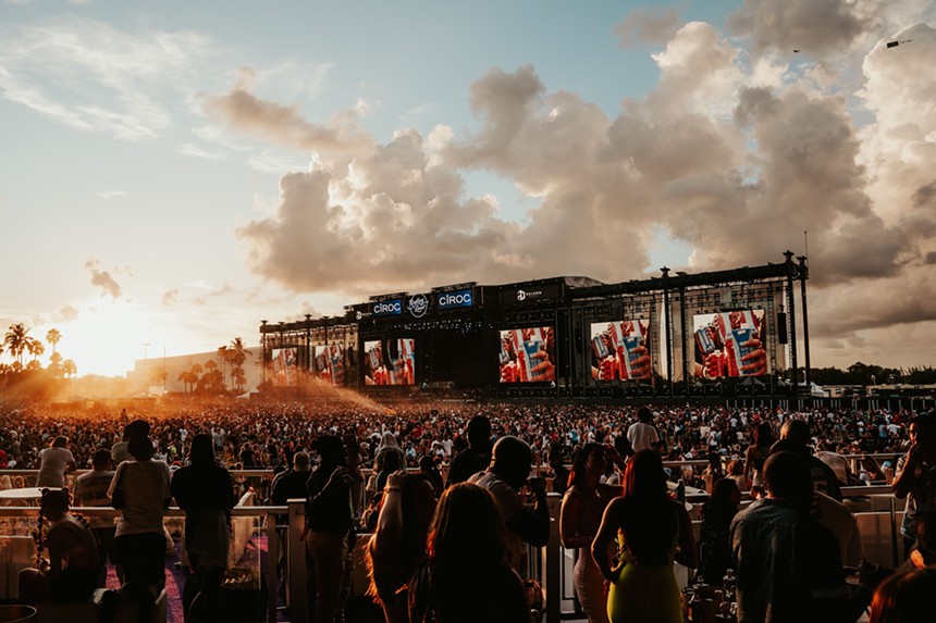 Crowd in front of the stage at sunset