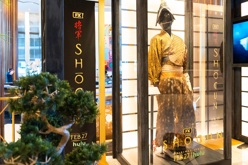 A Japanese costume on display in a window
