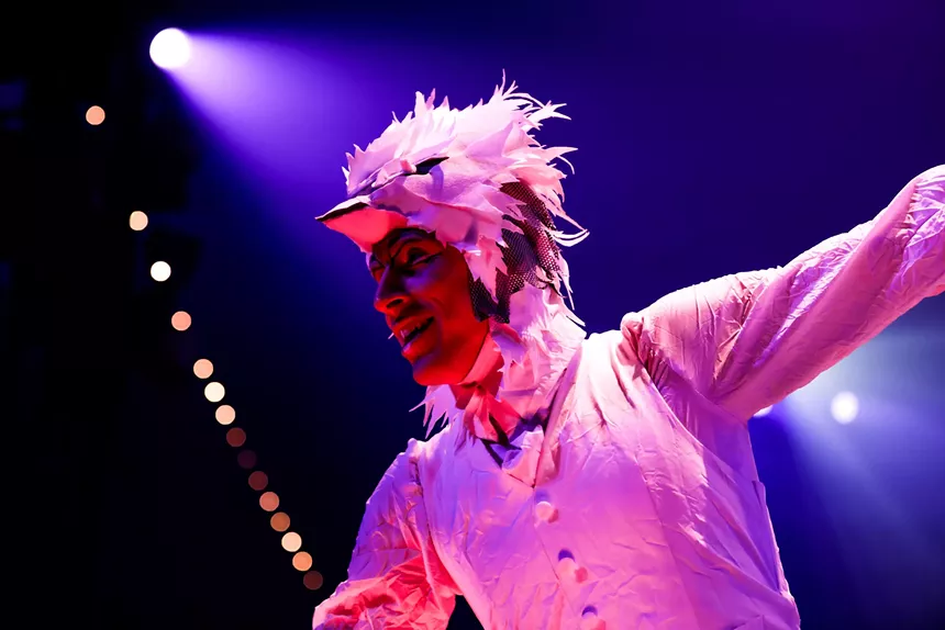 A Cirque du Soleil performer in an all-white outfit