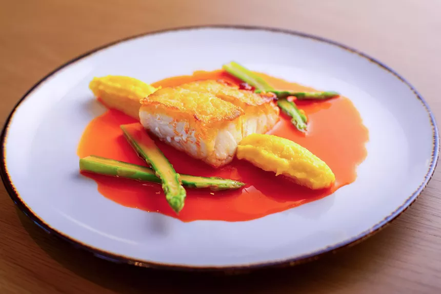A fish dish served on a white plate