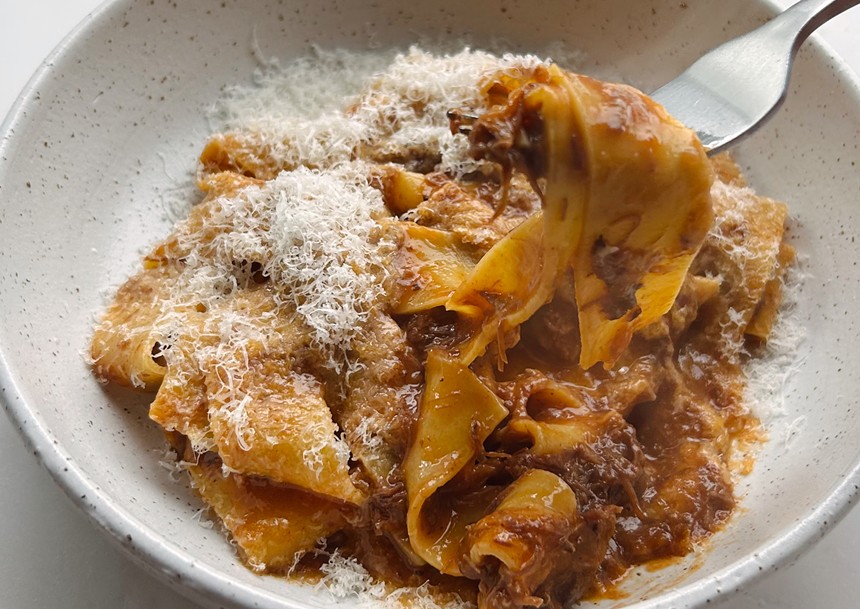 A beef and pasta dish on a white plate