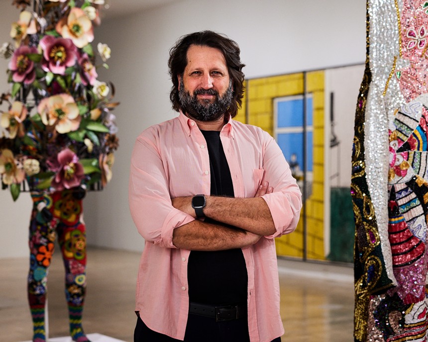 Michel Hausmann standing arms crossed in a gallery at the Rubell Museum