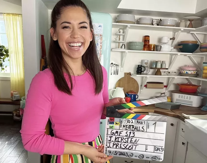 A woman wearing a pink shirt