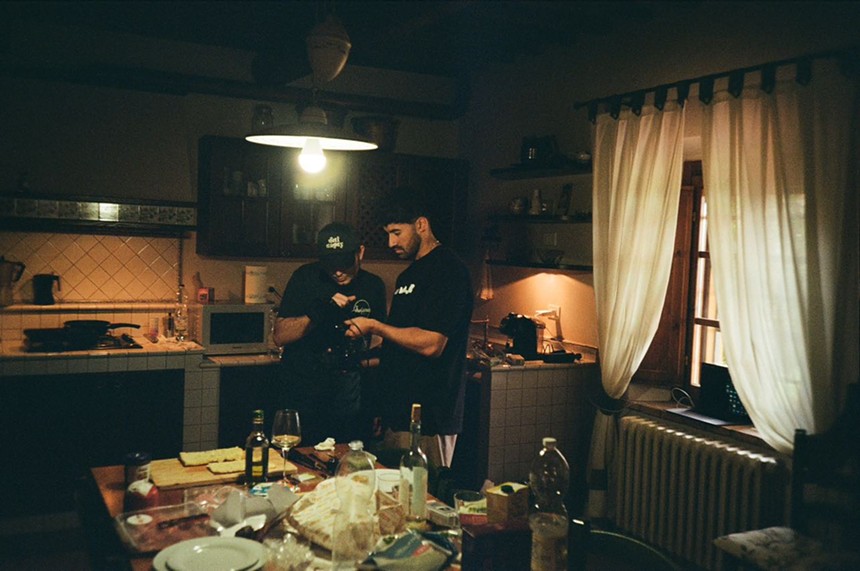 Two men shooting photos in a kitchen