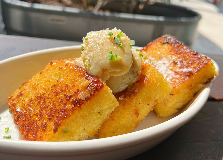 Cornbread with butter on a white dish