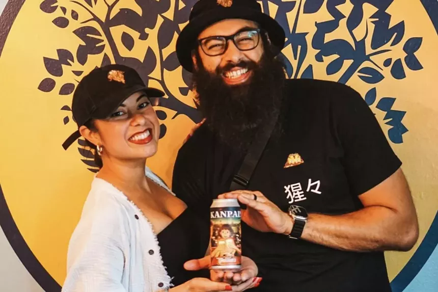 Man and wife hold a beer can