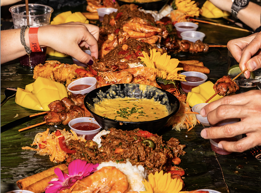 Hands eating food on a table