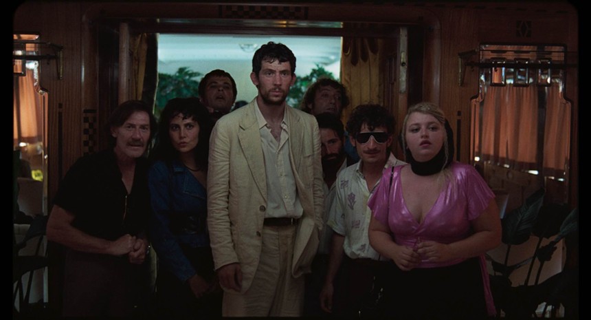 Josh O'Connor surrounded by the cast in La Chimera