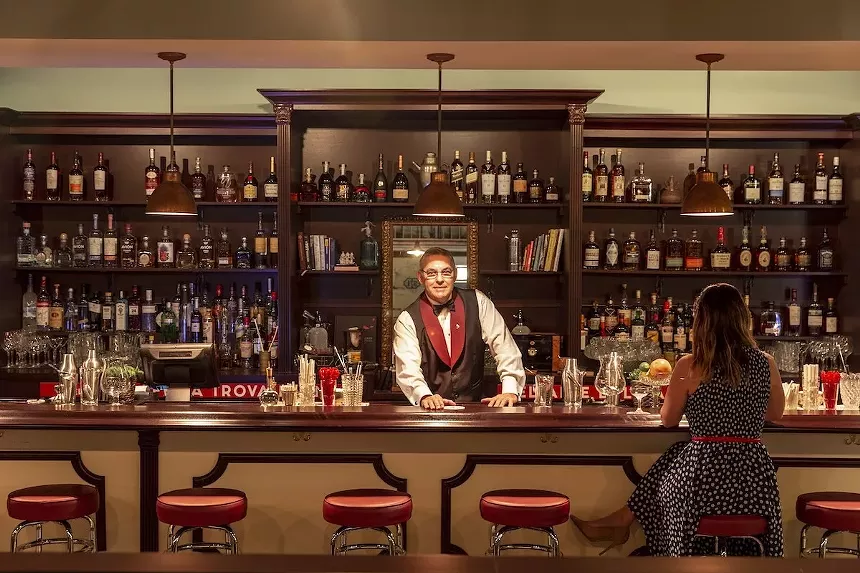 The bar at Cafe la Trova with a bartender ready to serve.