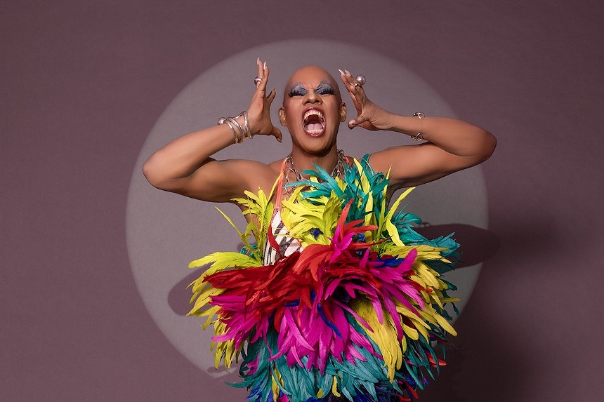 Kevin Aviance scream dressed in a colorful feathered costume