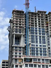A blue crane next to a high-rise building in downtown Fort Lauderdale after a fatal construction accident
