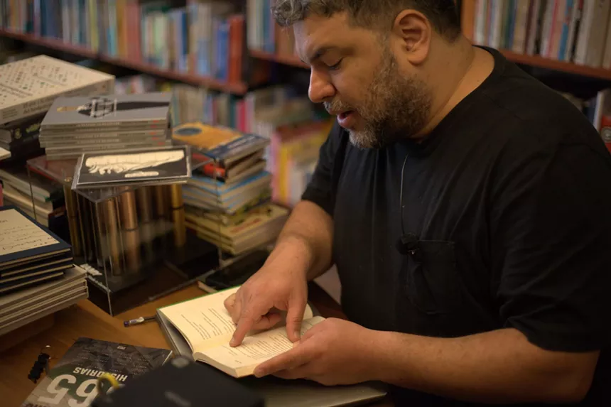Javier Masias looking down at a book
