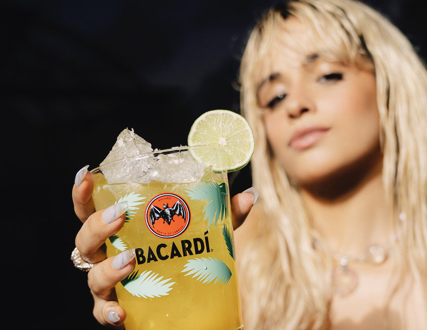 A woman holding a cocktail