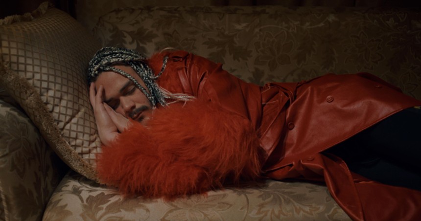 Still from the documentary Calls From Moscow of a man sleeping on a couch
