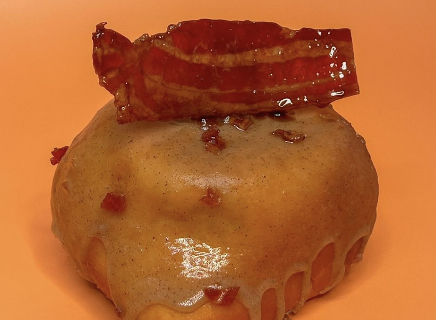 A doughnut with bacon on top