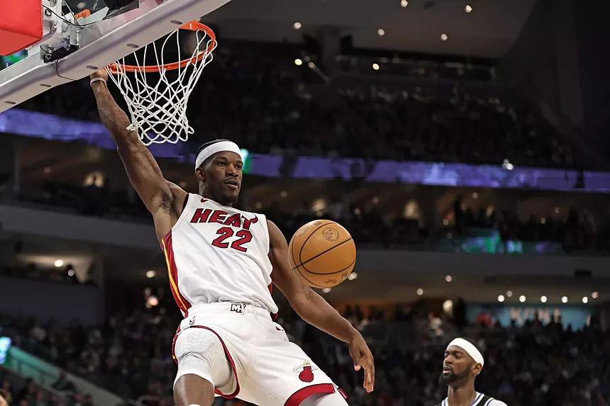 Photo of Miami Heat forward Jimmy Butler, a second or so post-dunk, looking fierce