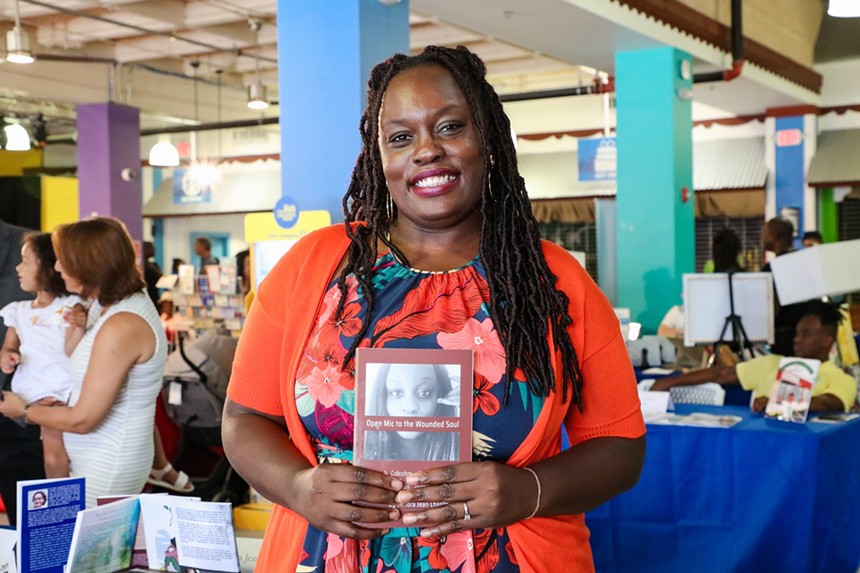 Author Sandra Jean Charite holding her book