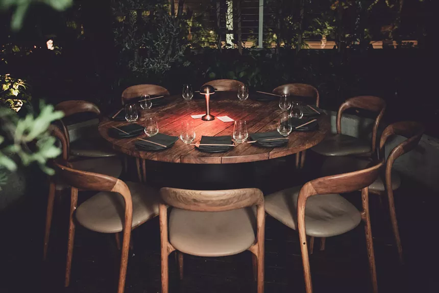 a dining table with wooden chairs