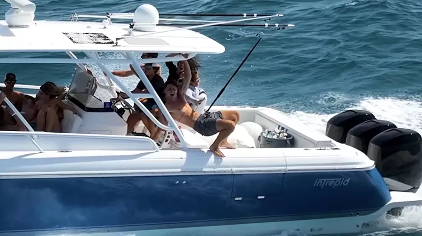 youtube screenshot of a fishing boat with a young man who appears to be engaging in a bout of crotch-thrusting (for want of a better term)