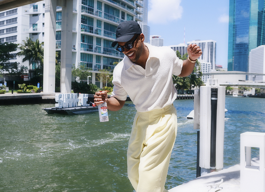 A man dancing on a boat with a hat on