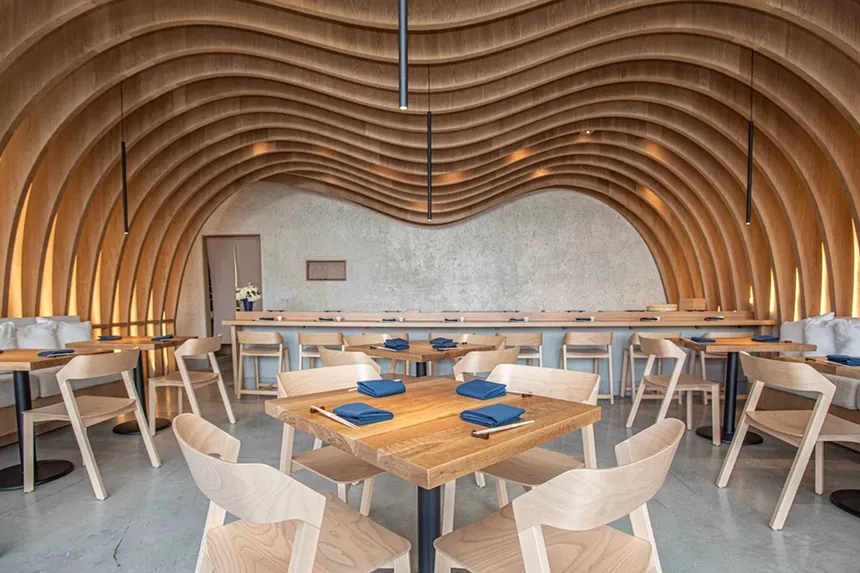 A modern dining room with wood beams