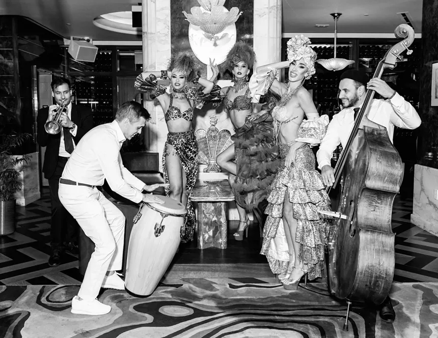 Dancers and band members posing from the camera inside Delilah