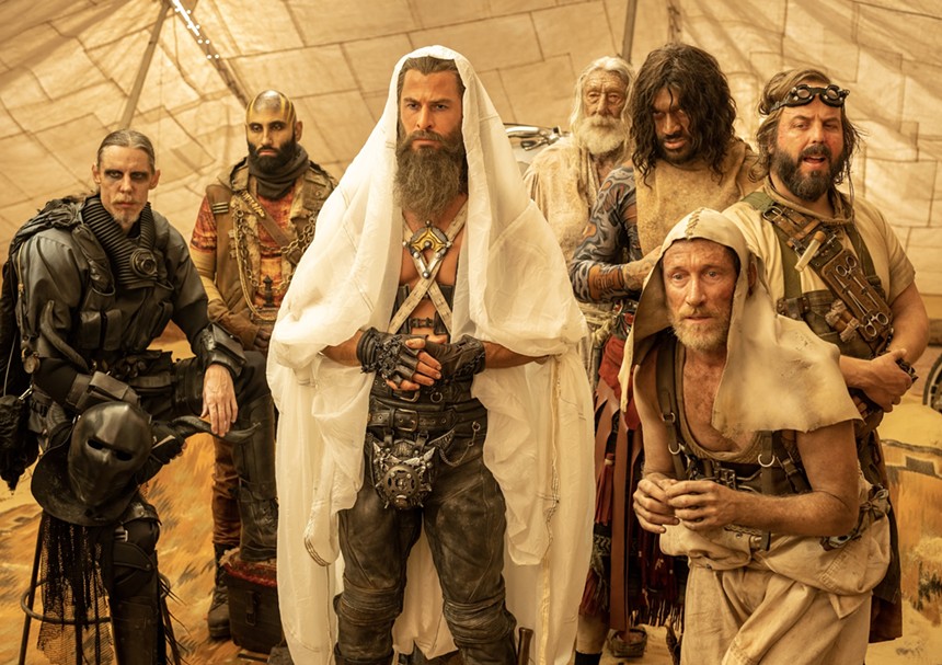 Still of Chris Hemsworth surrounded by other cast members in Furiosa