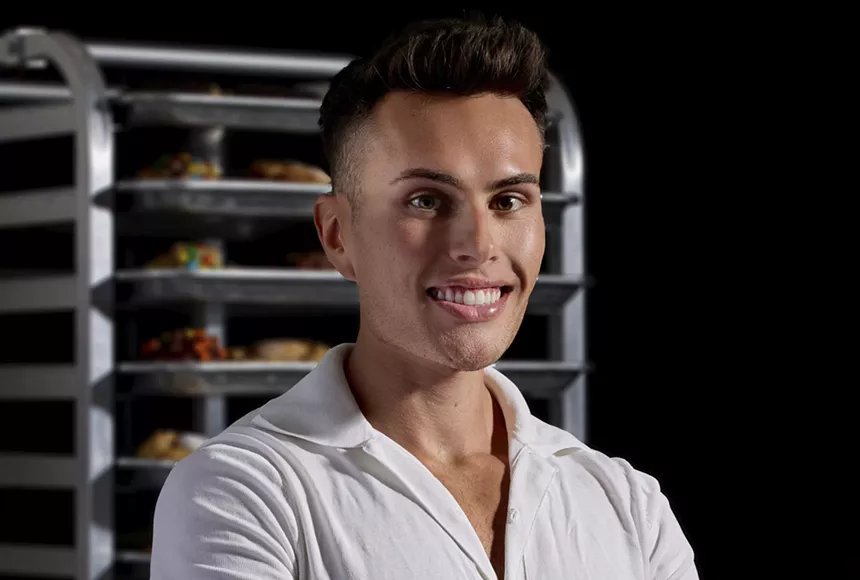 a man posing in a white shirt