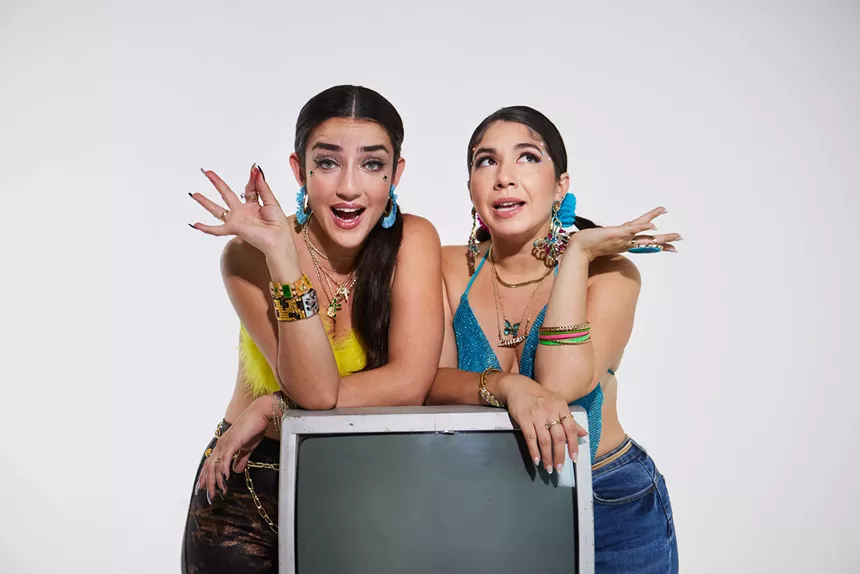 Portrait of Mimi Davila and Laura Di Lorenzo leaning on a television