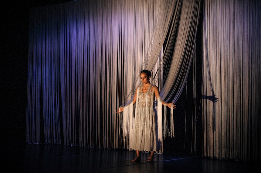Rosie Herrera emerging from a curtain