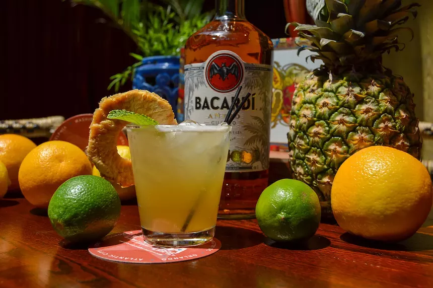 Cocktails and pineapples on a wood table