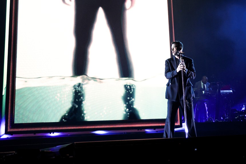 Justin Timberlake singing in front of a massive LED screen at the Kaseya Center
