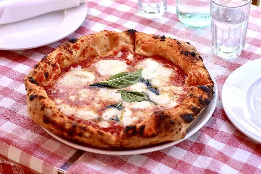 a pizza on a checkered table