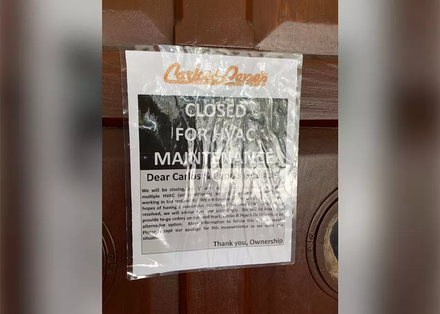 a printed paper on a wood door