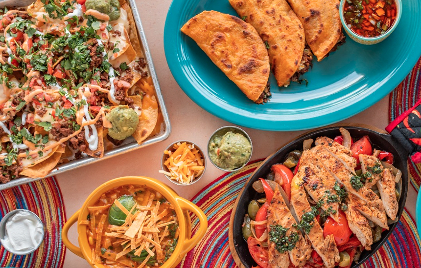 an assortment of Mexican dishes on a table