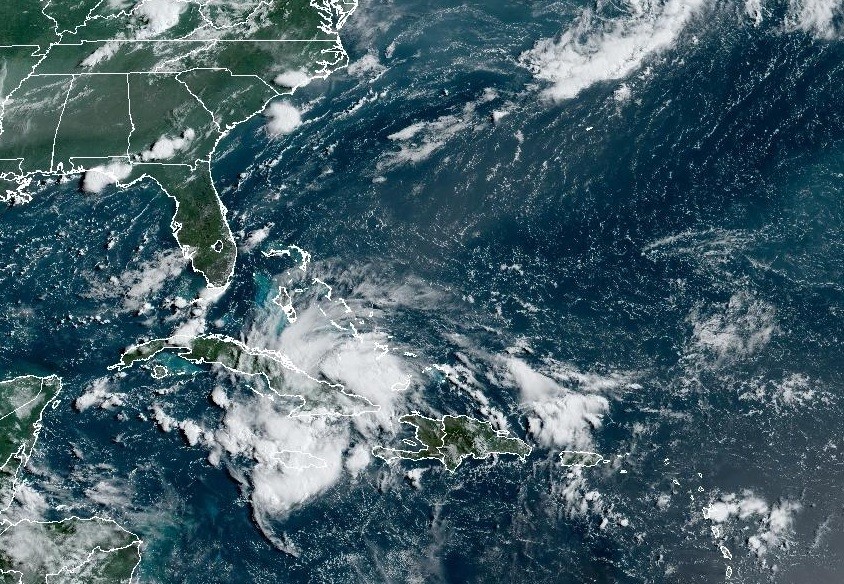 Satellite photo of a tropical disturbance in the Caribbean, appearing as a well-defined area of clouds