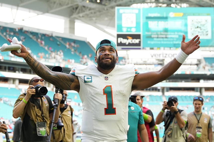 Miami Dolphins quarterback Tua Tagovailoa extends his arms in celebration after a victory