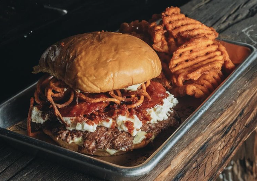 a cheeseburger with toppings