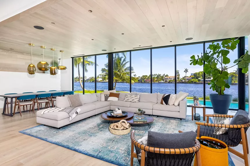 family room with floor-to-ceiling windows on the water