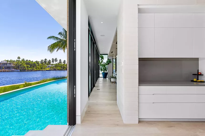 steps away from the kitchen is the entrance to the pool