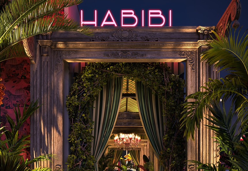 A silk curtain surrounded by greenery outside of a building