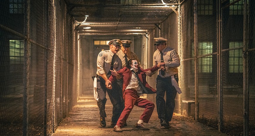 Still of police dragging Joaquin Phoenix in Joker: Folie à Deux