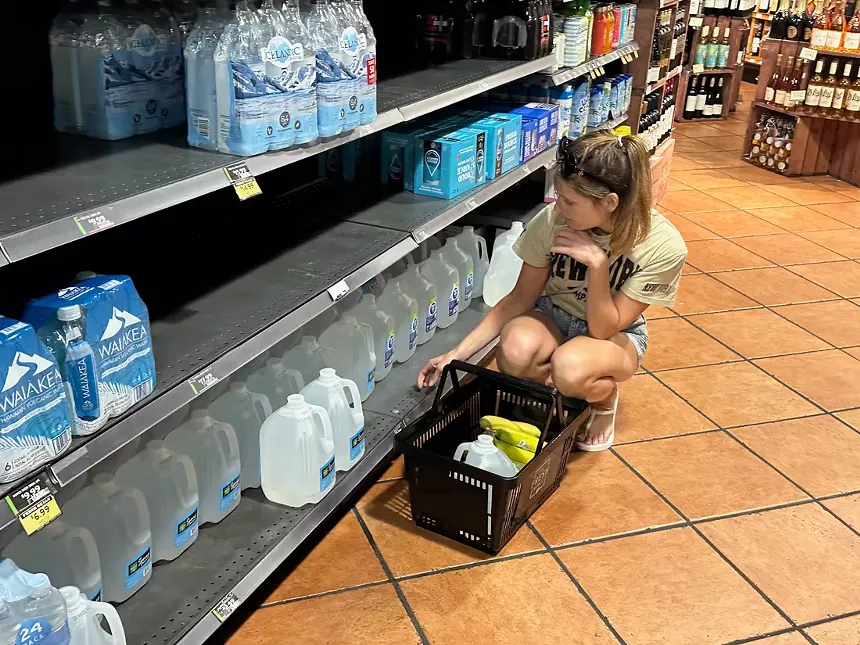 A woman purchases water at the Fresh Market in Aventura