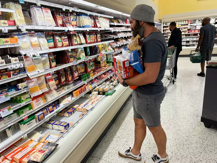 Man grabbing hurricane supplies at Publix