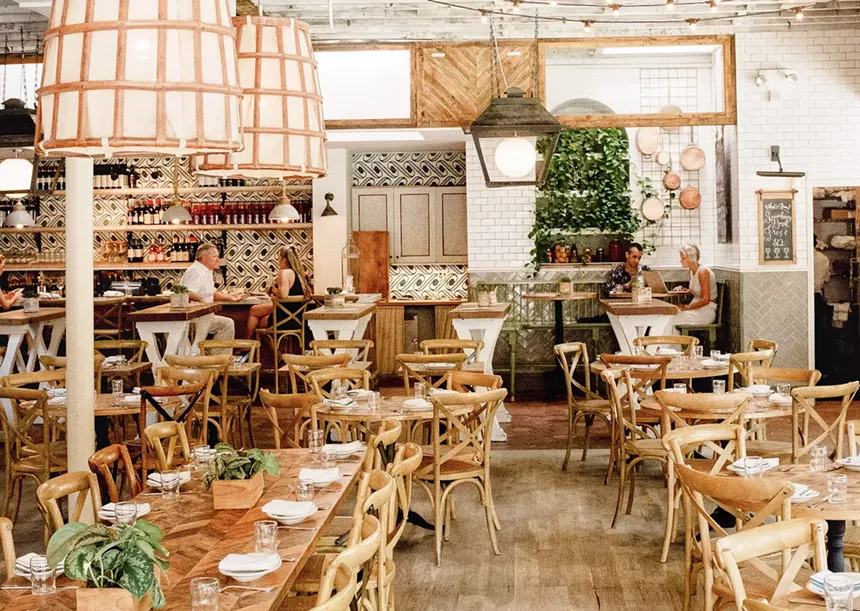 an airy dining room with tables and chairs