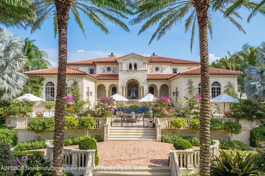 Backyard featuring a large pool, well-maintained garden, and oceanfront access